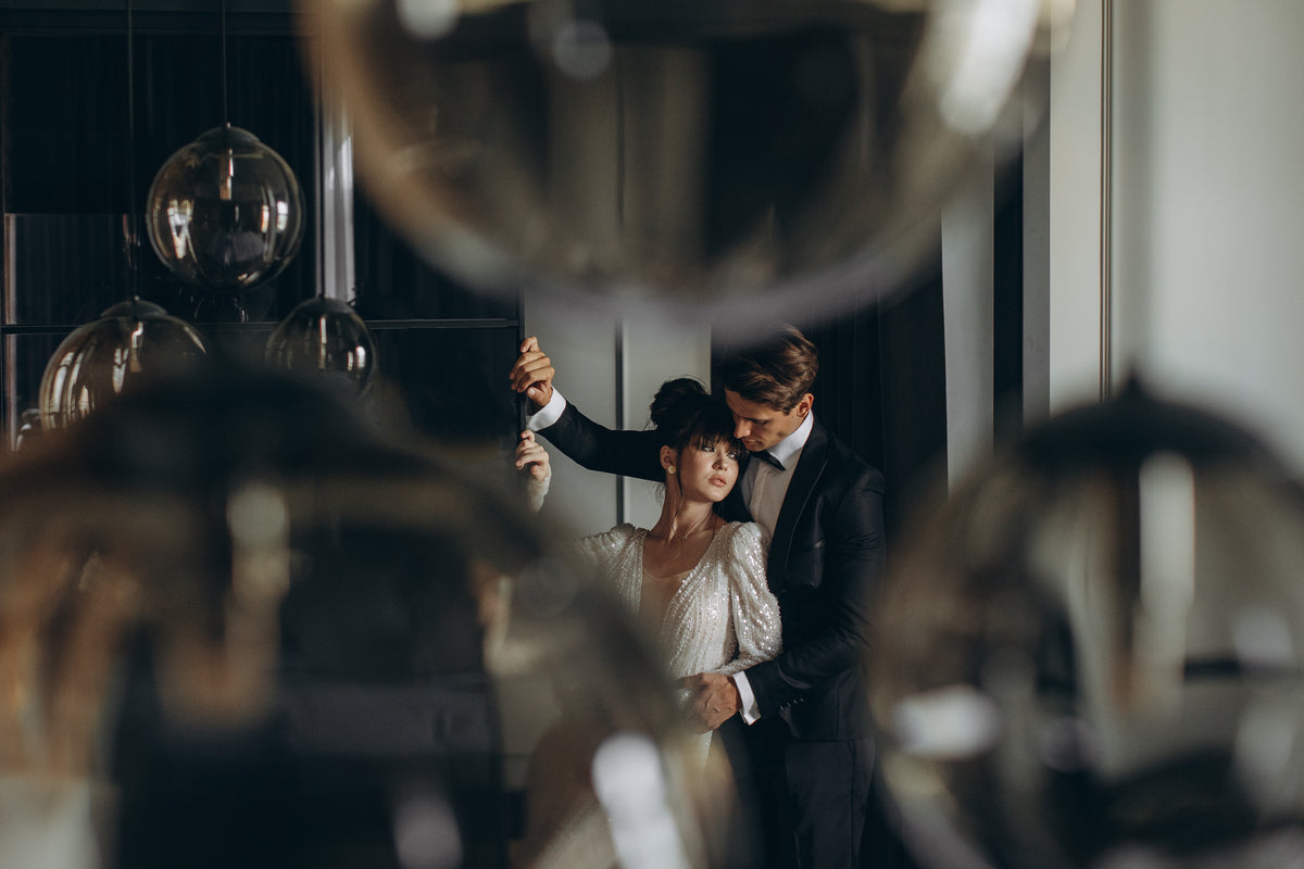 Couple dancing in a room with reflective surfaces
